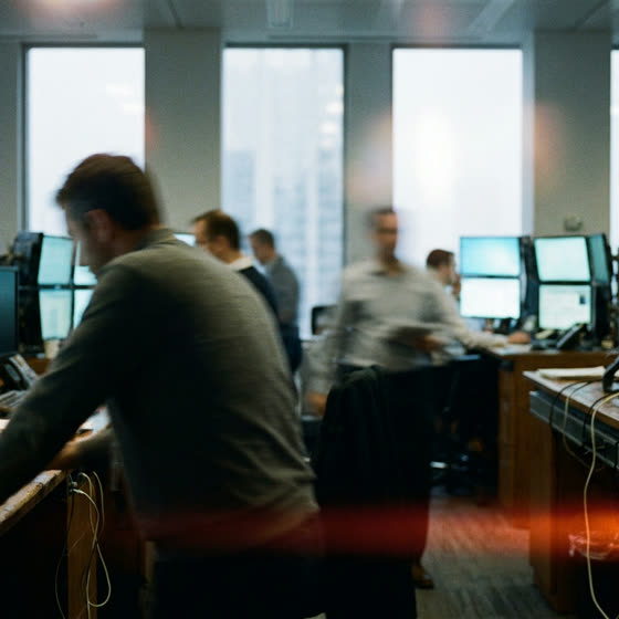 An open office floor with people at monitors